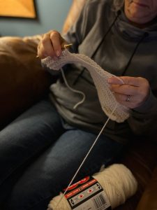Debbie crocheting a dog scarf directly from the skein.